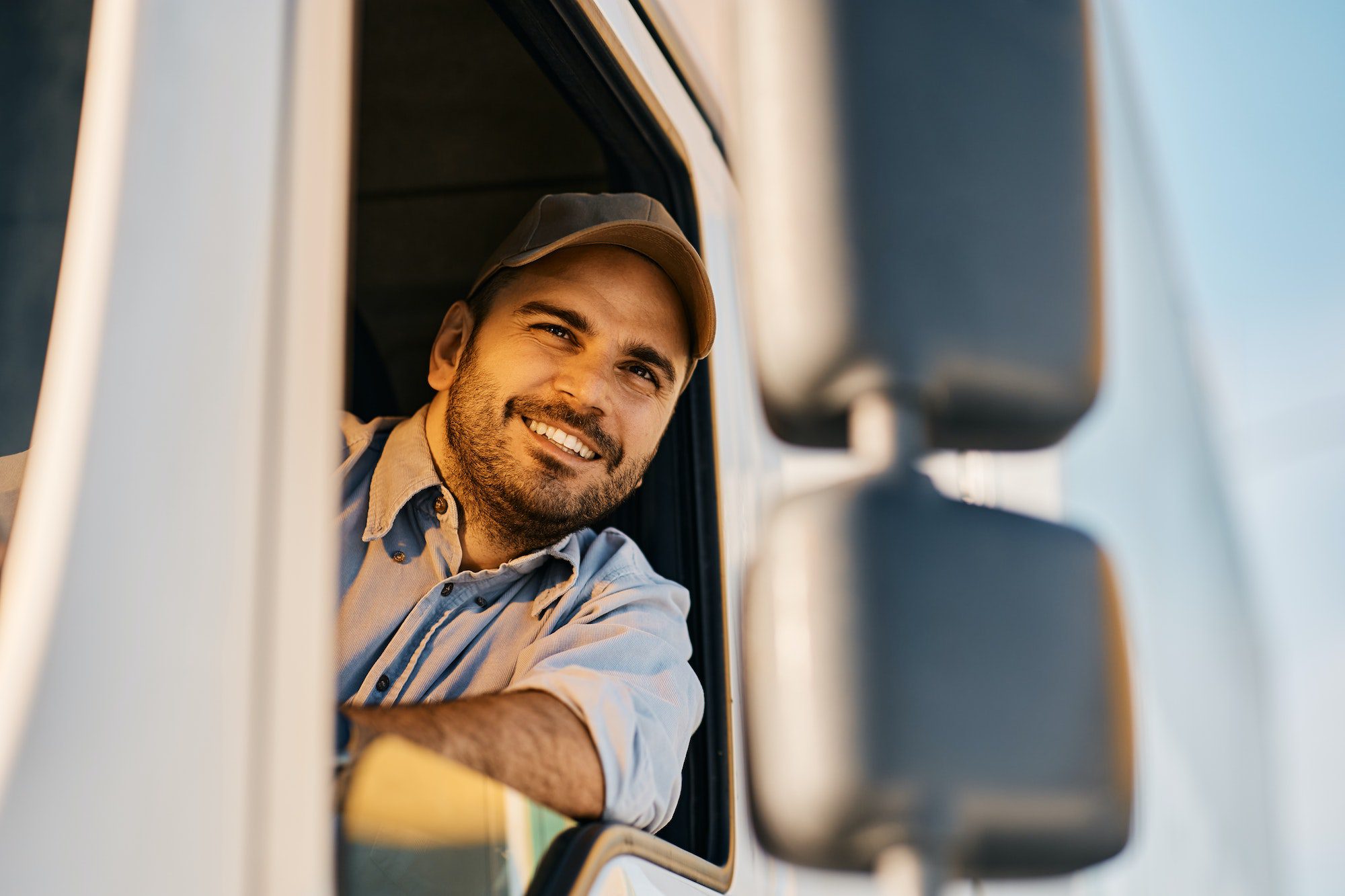 A man in the driver 's seat of a truck.