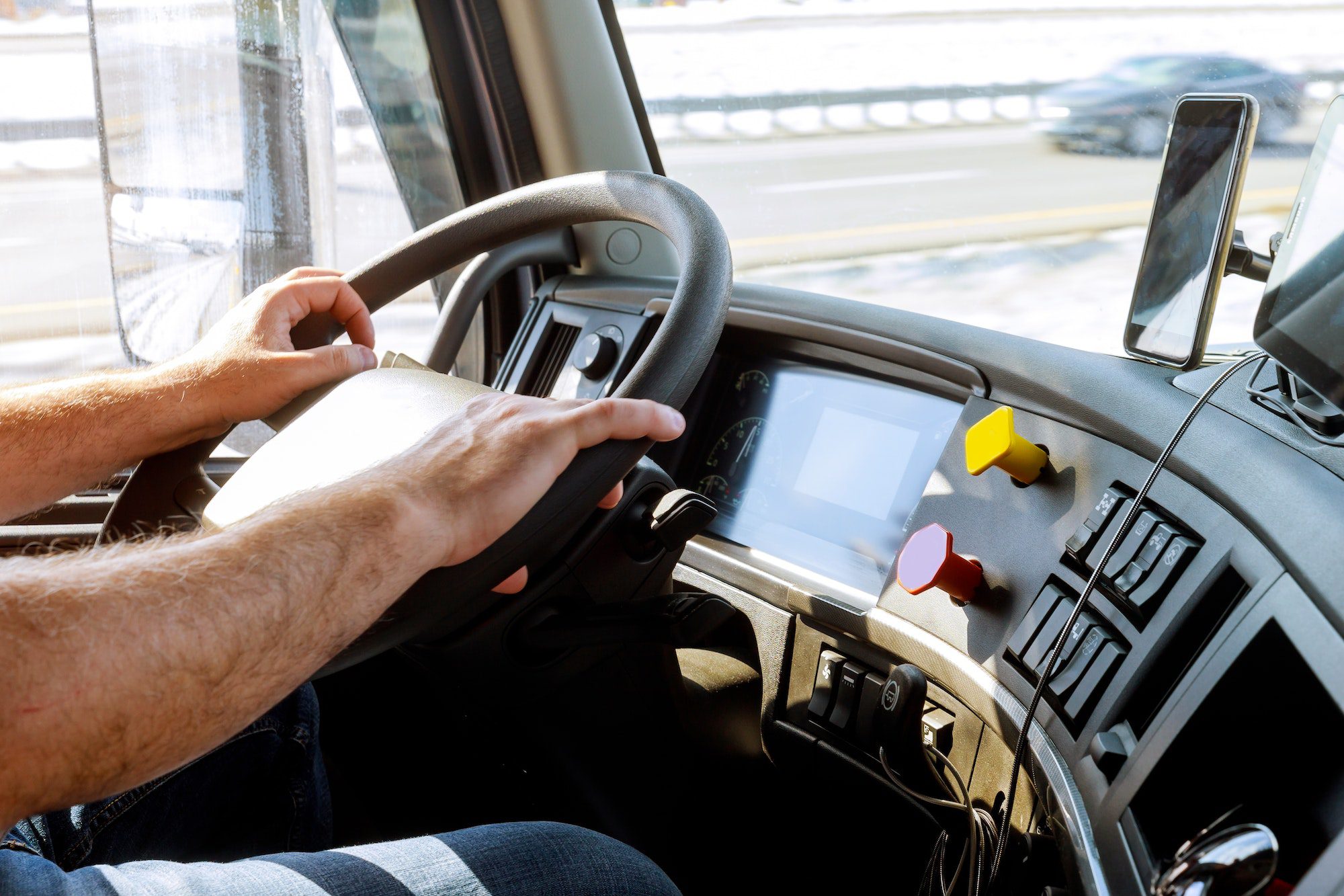 A person driving a truck with the dashboard turned on.